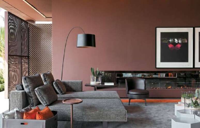 29. Sala com sofá cinza e parede rose com luminária moderna