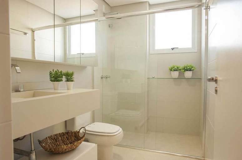 3. Modelo de banheiro simples com cores claras e pequenos vasos com plantas