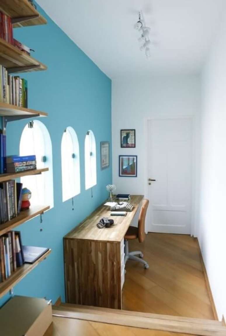 21. A parede azul deixa o home office com uma aparência menos séria. Projeto de Buji