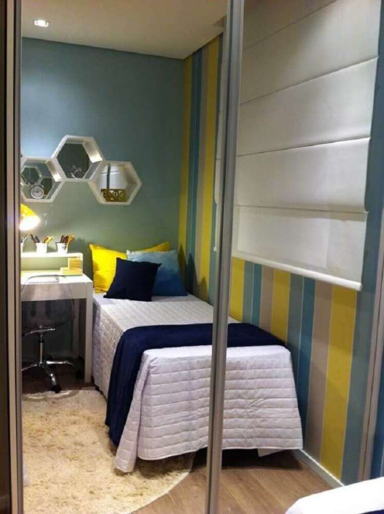 24. Papel de parede listrado de azul e amarelo para completar a decoração de quarto masculino