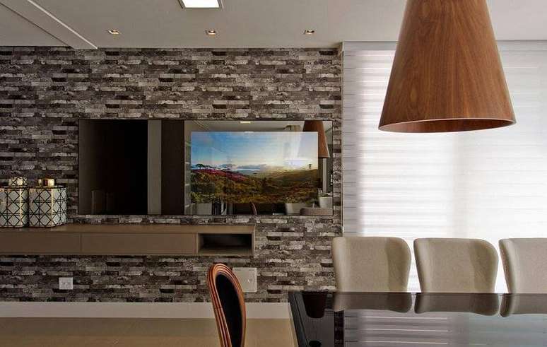 32. A sala de jantar com pedras cinzentas como revestimento de parede ganha ares modernos. Projeto por Espa&ccedil;o do Tra&ccedil;o