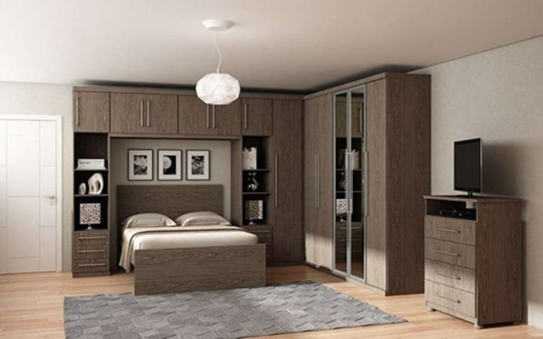 24- Decoração com guarda roupa modulado em madeira para quarto com cama embutida.