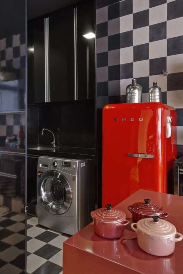 39. Cozinha com parede e chão quadriculado e geladeira colorida vermelha. Projeto de Gislene Lopes