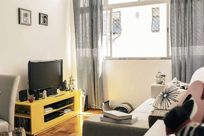 52. A decoração da sala de estar deve refletir a identidade dos moradores, como nesse projeto de Casa Aberta que utiliza um rack para TV amarelo