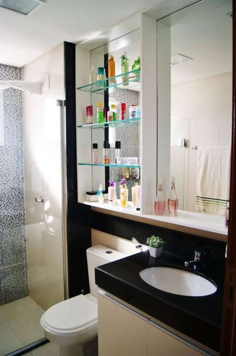 12. O modelo de espelho para banheiro com prateleira ajuda a organizar os cosméticos. Projeto por Priscila Fernandes