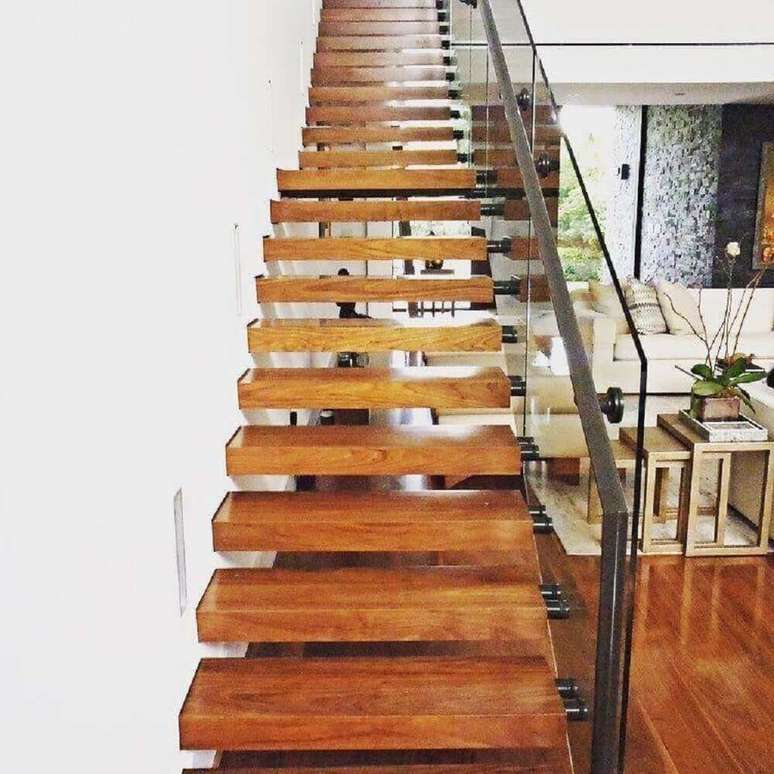 45. Escada de madeira para sala com guarda corpo de vidro e corrim&atilde;o de ferro