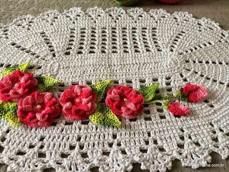 3. Uma das formas de como fazer folhas de crochê para tapetes é trabalhando-as em conjunto com flores coloridas