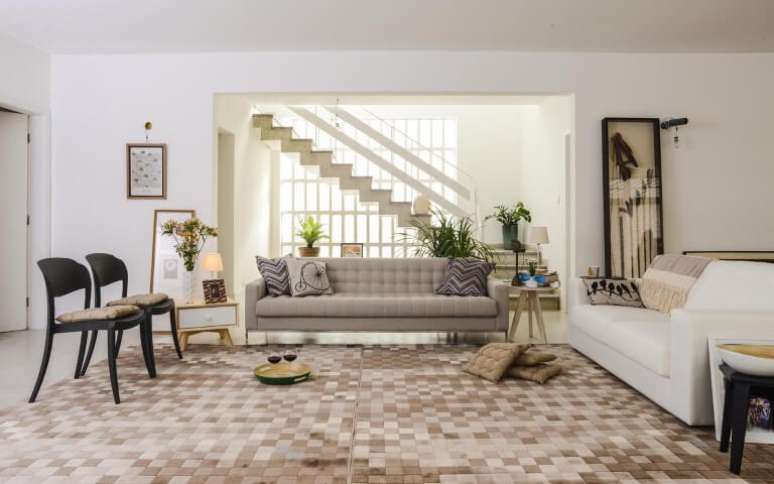 26. Sala de estar com mesas laterais diferentes aos lados do sof&aacute;. Projeto de Oppa