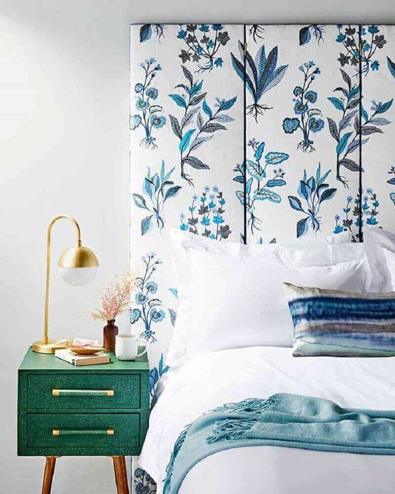 55. Quarto decorado com cabeceira para cama de casal com estampa floral azul e criado mudo verde