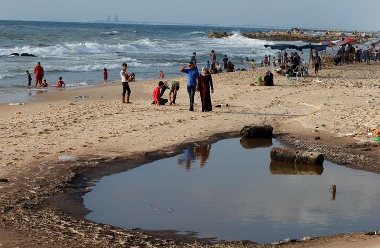 Palestinos em praia poluída de Gaza 13/07/2018 REUTERS/Mohammed Salem