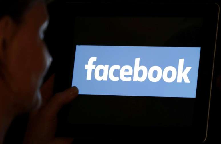 Uma mulher olha para a logomarca do Facebook em um iPad 3/06/ 2018. REUTERS/Regis Duvignau/