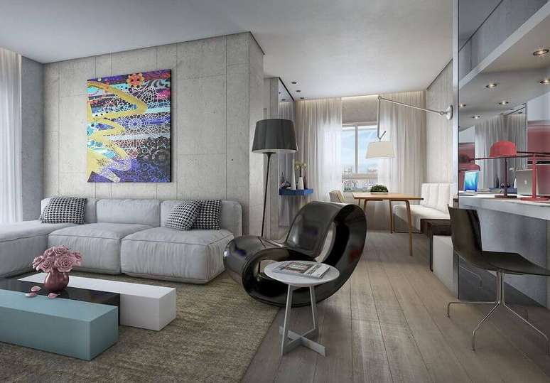 33. Decoração moderna com parede de cimento queimado, sofá modulado e quadros decorativos grandes para sala