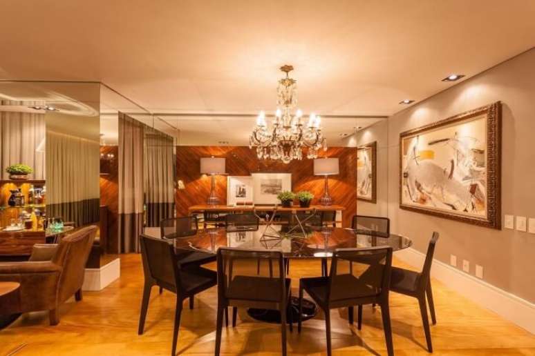 45. Ao posicionar os lustres para sala sobre a mesa de vidro &eacute; poss&iacute;vel criar uma sensa&ccedil;&atilde;o de amplitude e deixar o ambiente ainda mais iluminado. Projeto de Juliana Pippi