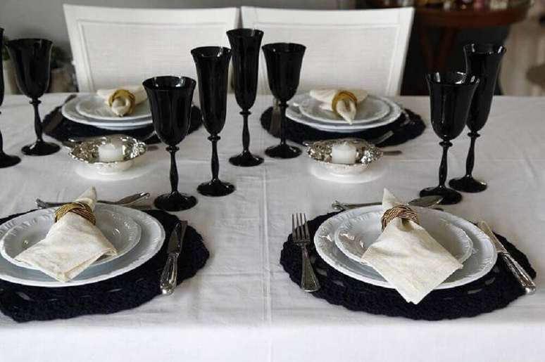 35. Decoração para mesa de jantar em tons de preto e branco com porta guardanapos