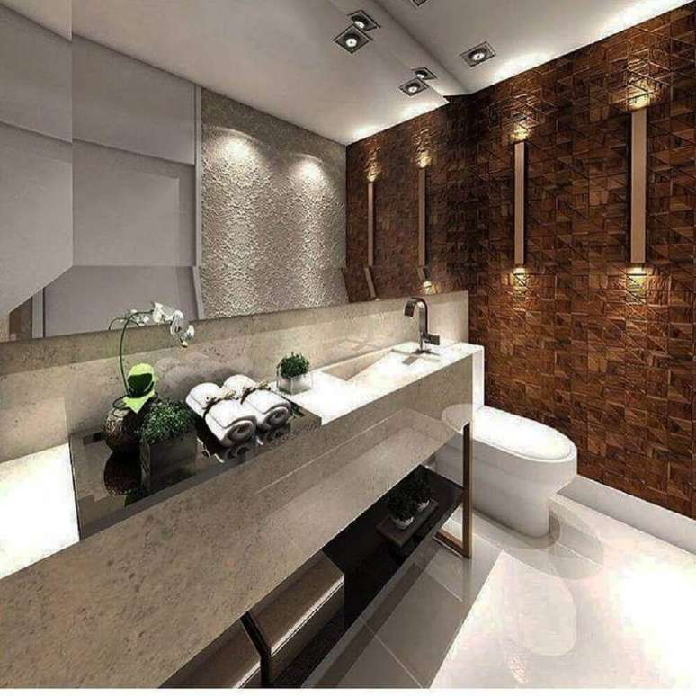 21. Banheiro decorado com textura nas paredes e pia oculta em granito Foto: Imagine Você Aqui