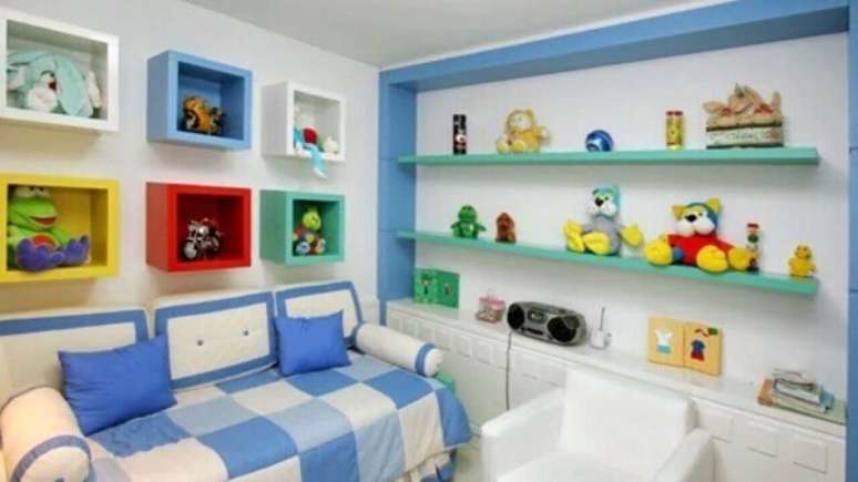 41- Quarto de criança com prateleiras coloridas que combinam com a colcha da cama. Fonte: Pinterest