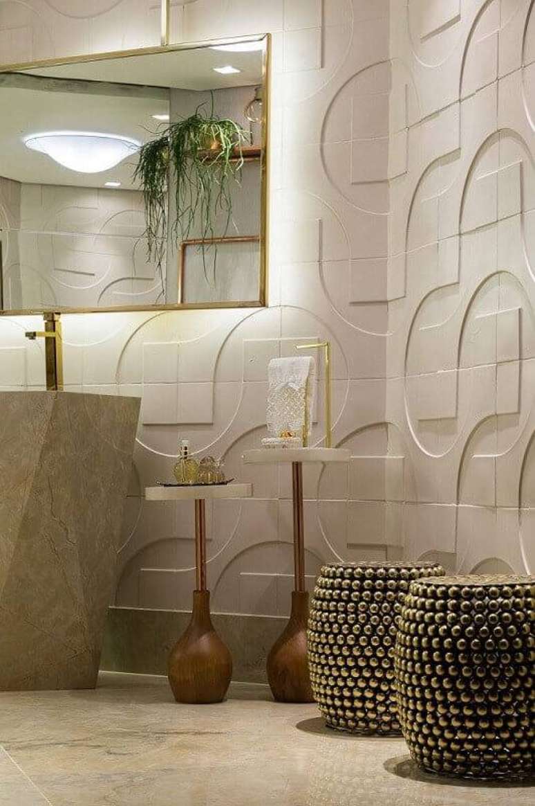 36. O banheiro com revestimento 3D grande fica moderno e elegante. Projeto por Morar Mais por Menos Goiânia.