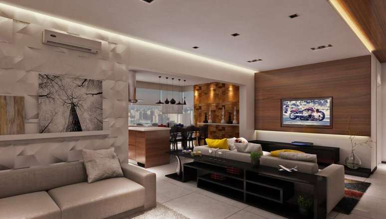 23. A sanca de gesso harmoniza com o revestimento 3D na sala de estar. Projeto por Raduan Arquitetura.