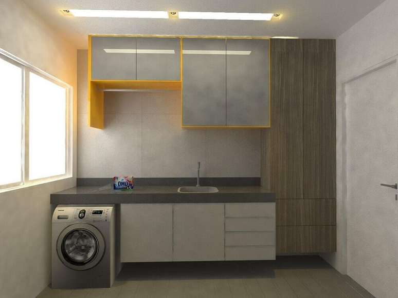 32. Decoração para lavanderia amarela e cinza com armário para área de serviço – Foto: Larissa Vinagre