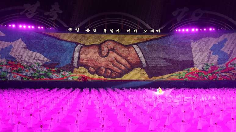 A mural of shaking hands is displayed during a "mass games" gymnastic and artistic performance at the May Day Stadium in Pyongyang
