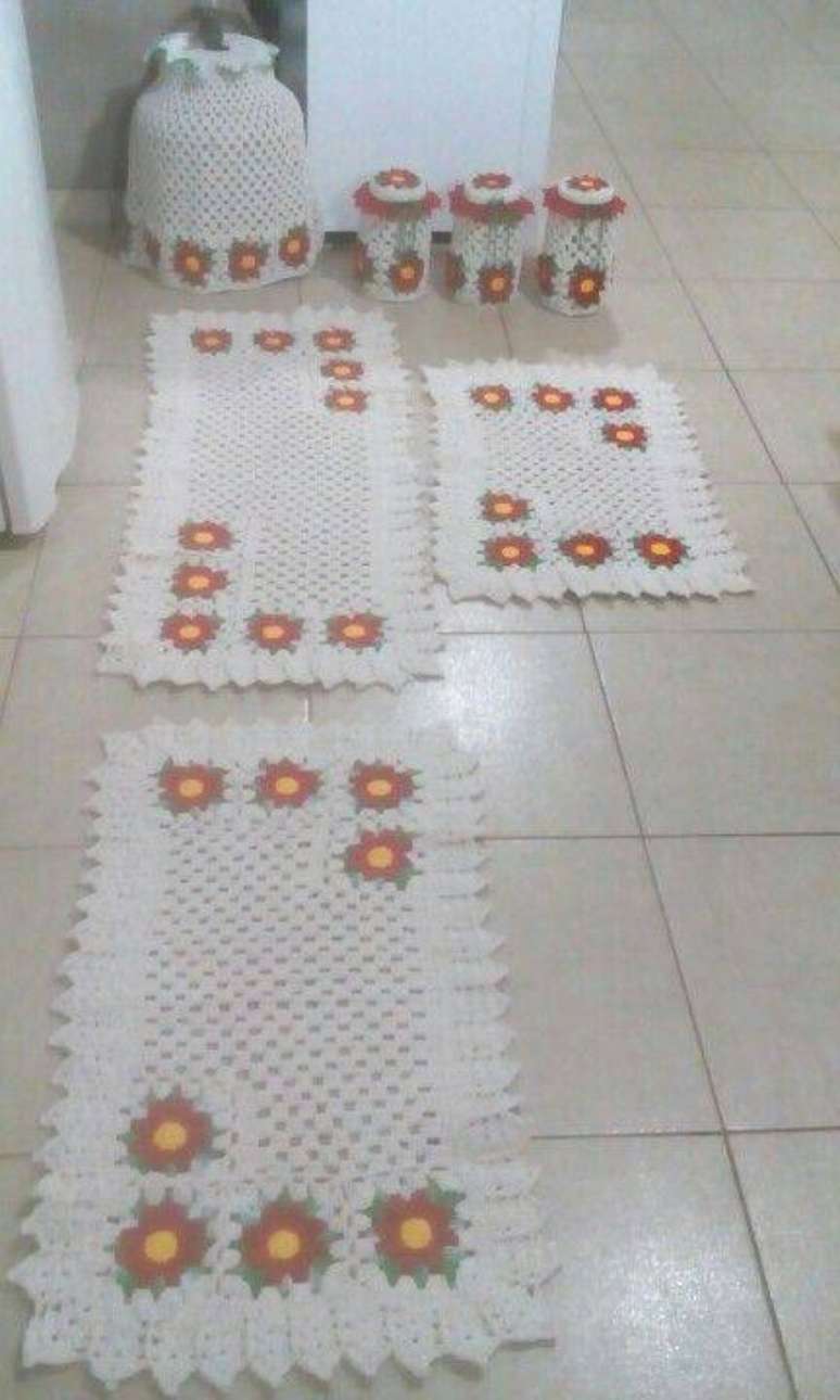 71. O tapete de crochê para cozinha combinando com os demais itens de barbante deixa a decoração muito meiga