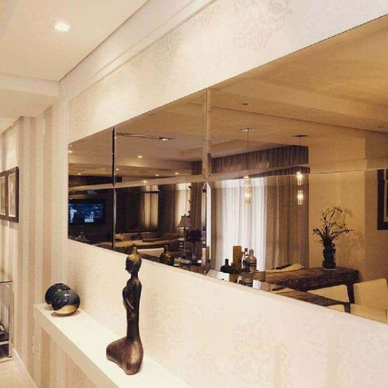 18. Corredor decorado com espelho de bronze e pequena bancada branca &ndash; Foto: Elaine Castanheira Arquiteta