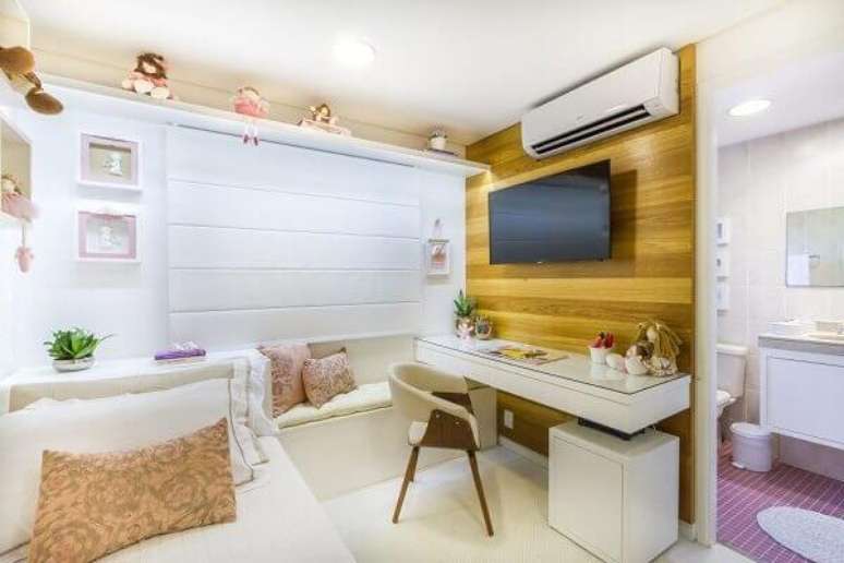2- O painel de tv para quarto em madeira aparente tem escrivaninha embutida. Fonte: Bordin & Soares