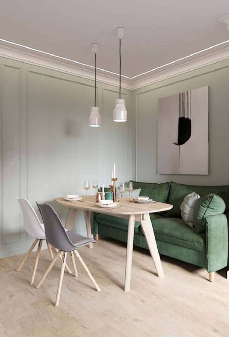 54. Moldura de parede para sala com sofá verde e mesa de madeira – Foto: Pinterest