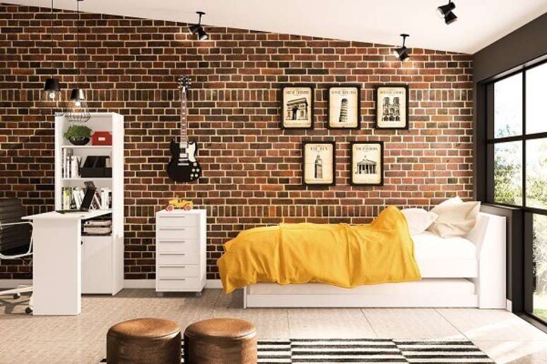 1- Decorando quarto para jovens você pode utilizar parede de tijolinhos, quadros e instrumento musical na decoração. Imagem: Politorno