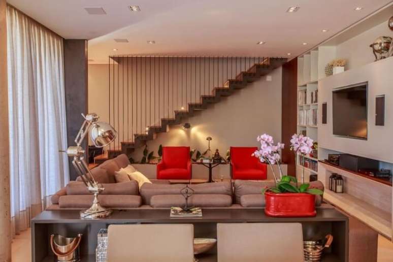 26. Decora&ccedil;&atilde;o de sala em tons neutros com poltronas vermelhas de destaque. Projeto de WT Studio