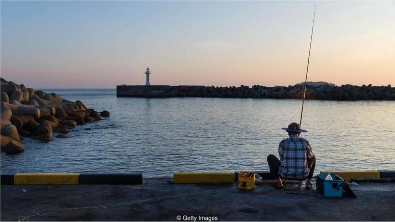 Pescador no porto em Seogwipo, na ilha Jeju, Coreia do Sul