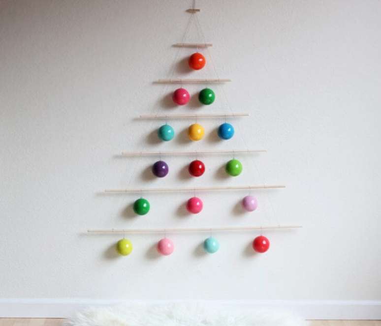 32. Você pode também fazer uma árvore de natal minimalista com enfeites para árvore de natal coloridos. Foto de In Habitat