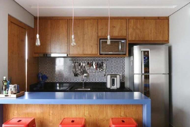 27. Cozinha planejada pequena com balcão azul e armário de madeira – Foto: GF Projetos