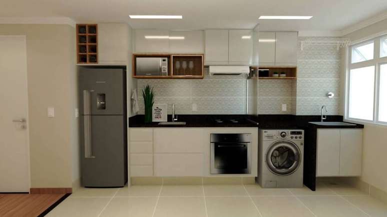39. Área de serviço planejada integrada à cozinha com apenas uma separação de vidro. Projeto de Julia Paraluppi Ferreira