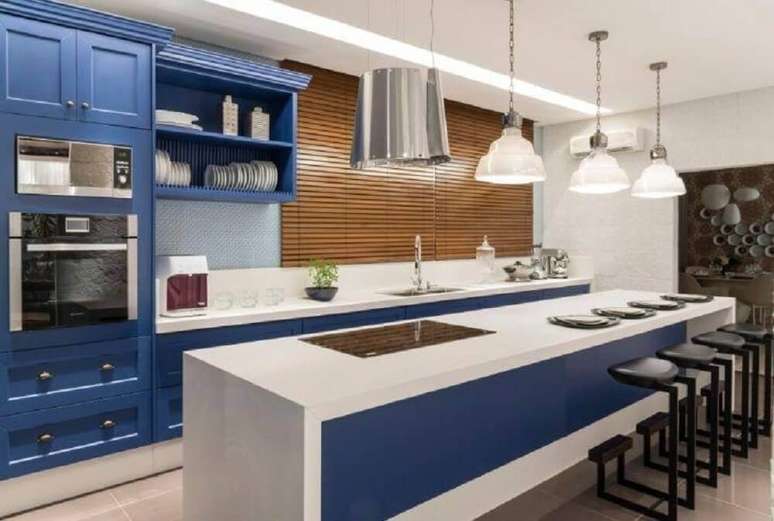 22. Decoração para cozinha planejada azul com banquetas pretas e pendentes sobre a bancada – Foto: Finat Moveis Ind Com Ltda