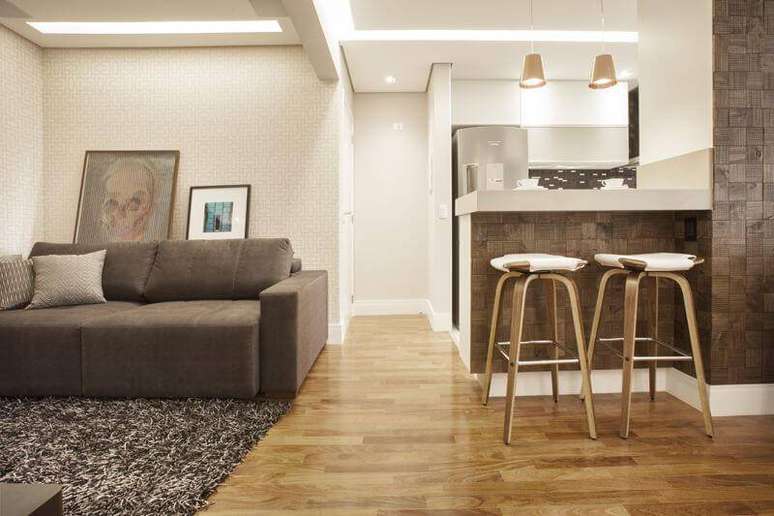 22. Sala integrada &agrave; cozinha americana com piso de madeira. Projeto de Carolina Vilela