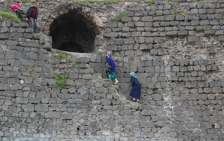 Mulheres sobem às muralhas da cidade romana da UNESCO, em Diarbaquir, Turquia