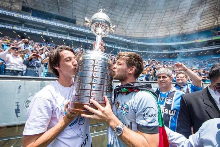 Os gremistas Pedro Geromel e Kannemann beijam a taça da Libertadores conquistada em 2017