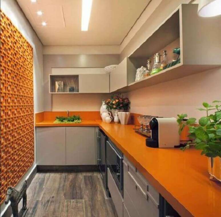 6- Na cozinha, o silestone laranja combina com elemento vazado da parede na mesma cor. Fonte: Papo Design