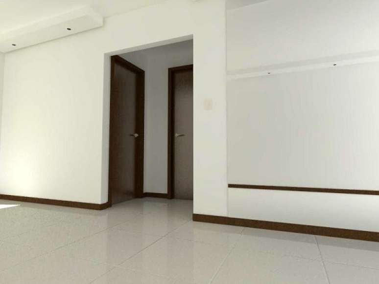 17- O rodap&eacute; de madeira marrom combina com as portas e guarni&ccedil;&otilde;es no apartamento com paredes e pisos claros. Fonte: Constru&ccedil;&atilde;o e Decora&ccedil;&atilde;o de Casas