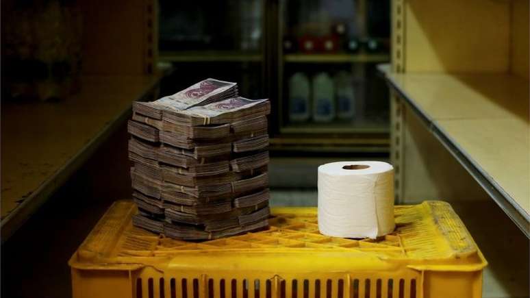 A pilha de bolívares necessária para comprar um papel higiênico; o governo de Maduro cortou alguns zeros da moeda para tentar conter a desvalorização