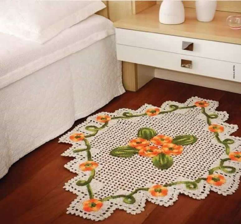 43. Quarto decorado com modelo diferente de tapete de crochê com flores laranjas – Foto: Artesanato Brasil