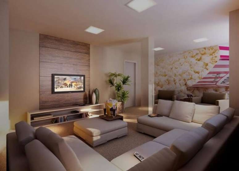 35- Na sala de TV as paredes e estofados tem a cor palha. Fonte: ConstruindoDECOR