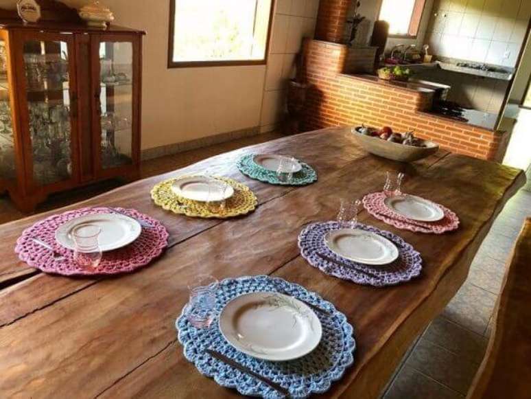44- Na sala r&uacute;stica, os jogos de sousplat de croch&ecirc; coloridos decoram a mesa. Fonte: Fios de Maria