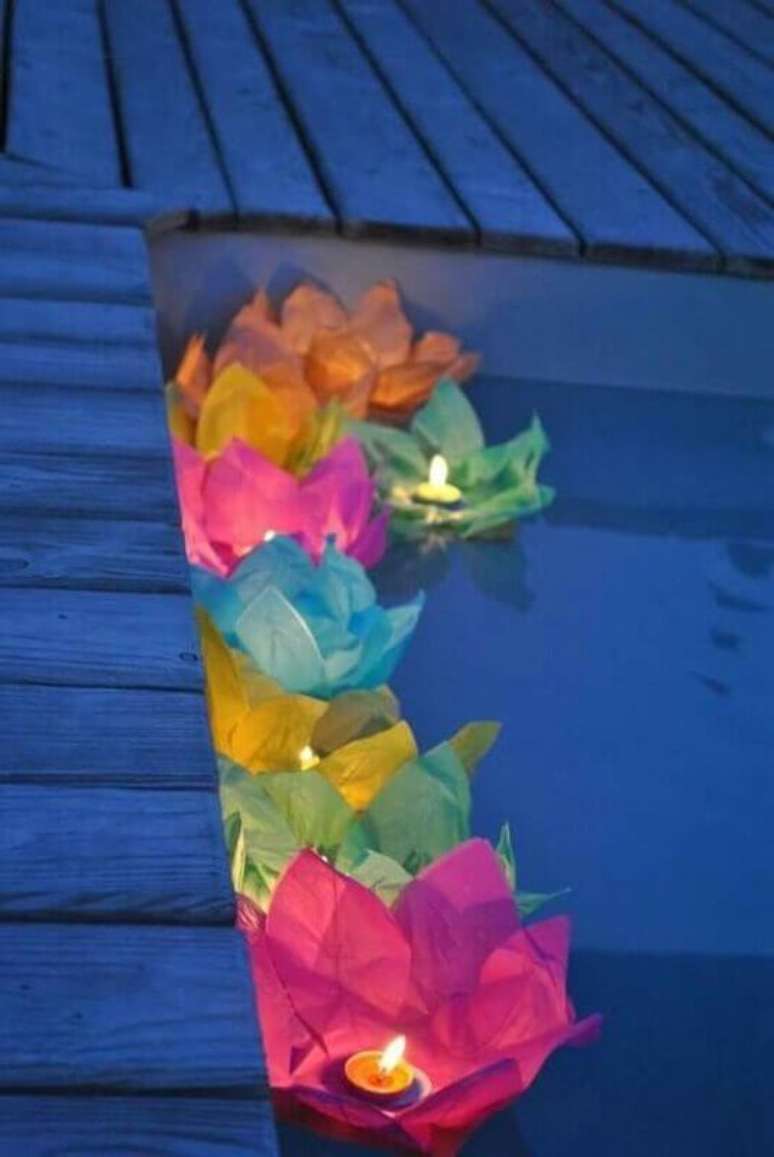 55. Decora&ccedil;&atilde;o festa havaiana luau com velas dentro de flores na piscina &ndash; Foto: Pinterest