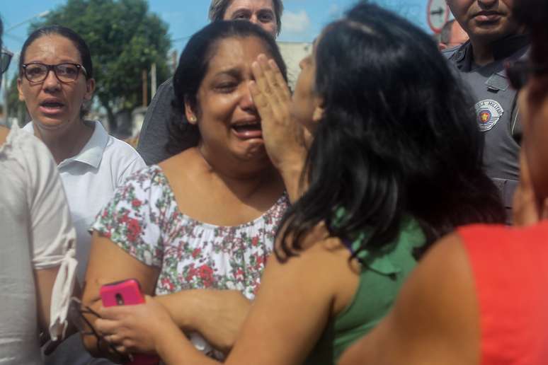 Mulheres buscam por informações após tiroteio ocorrido na Escola Estadual Raul Brasil de Suzano, na Rua Otávio Miguel da Silva, em Suzano, na Grande São Paulo, nesta quarta-feira (13)