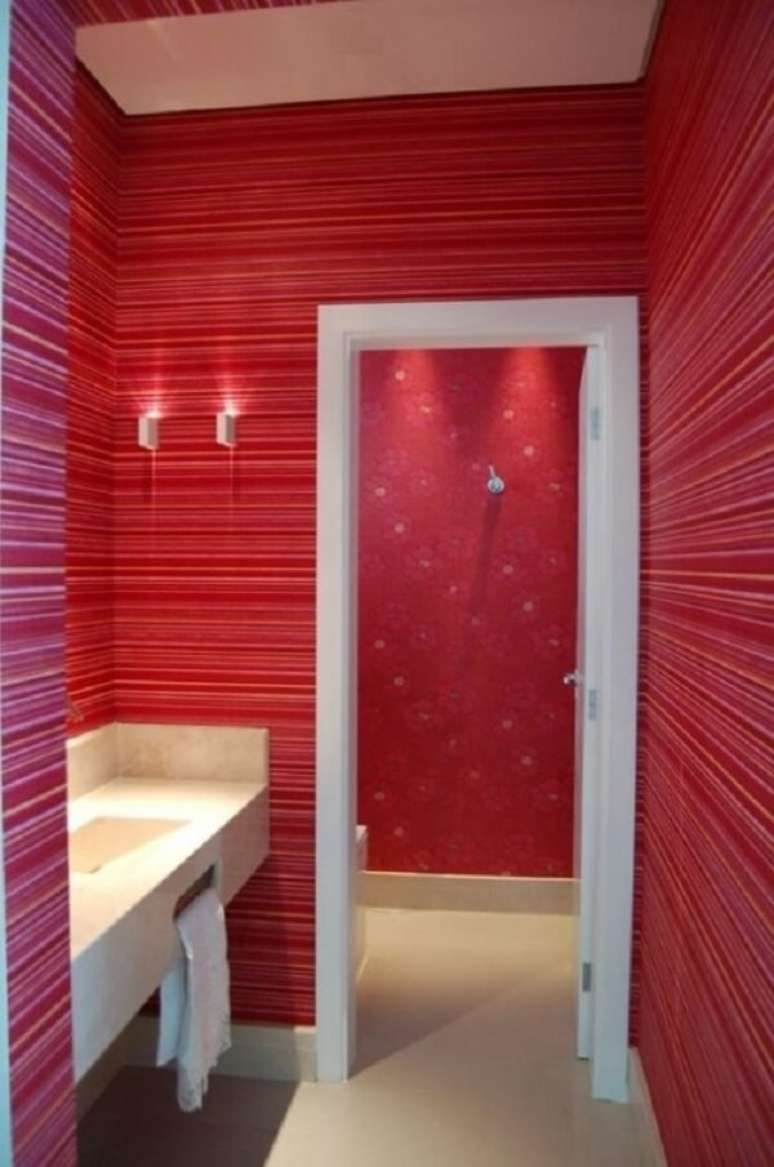 54- O papel de parede para lavabo tem listras na área da pia e flores na área do vaso. Fonte: Ateliê Revestimentos