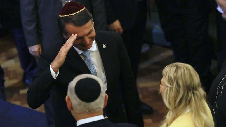 Em foto de dezembro, Bolsonaro cumprimenta Benjamin Netanyahu e sua mulher em visita do premiê ao Rio; agora, é o brasileiro quem viaja a Israel