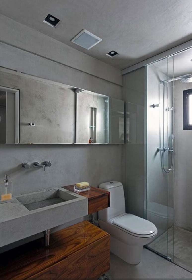 12. O cimento queimado é perfeito para deixar um toque moderno e aconchegante no banheiro masculino – Foto: Pinterest
