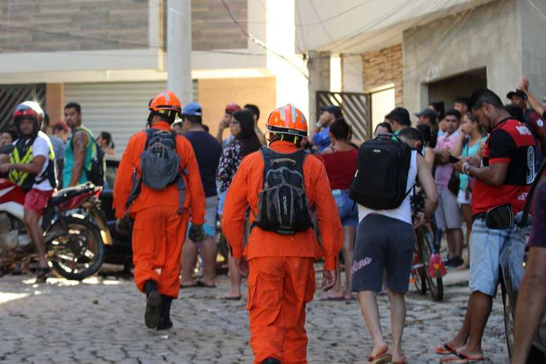 Dezenas de pessoas e bombeiros vasculham os escombros para tentar localizar vítimas após desabamento de prédios em Muzema, na Zona Oeste do Rio